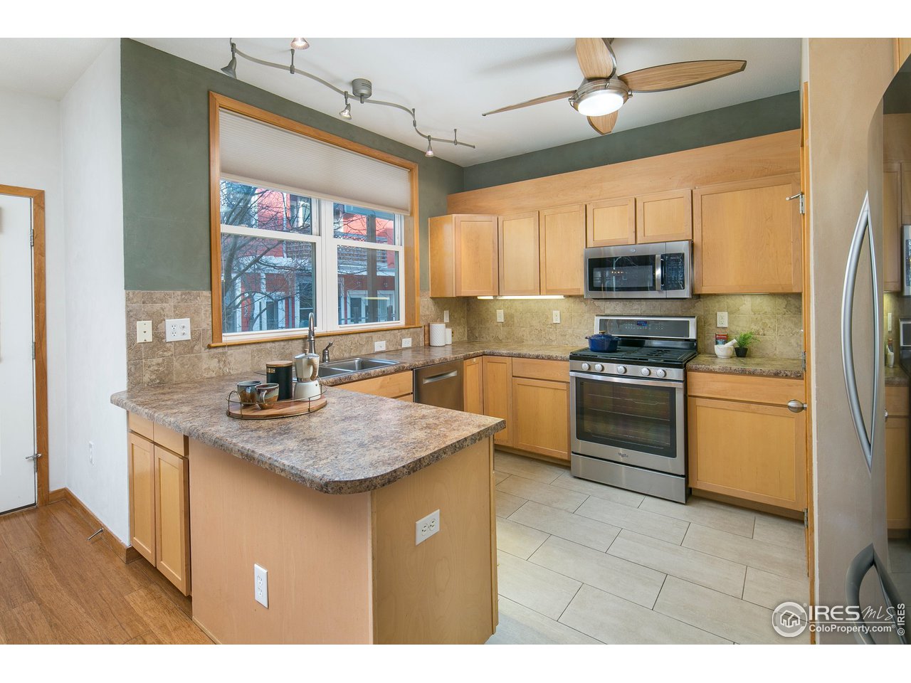 4742 16th Street Boulder, CO 80304 - Photo 11 of 38 a kitchen with stainless steel appliances granite countertop a sink stove and refrigerator