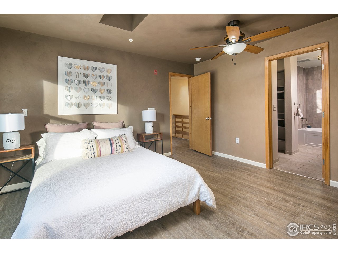 4742 16th Street Boulder, CO 80304 - Photo 15 of 38 a bedroom with a large bed and a chandelier