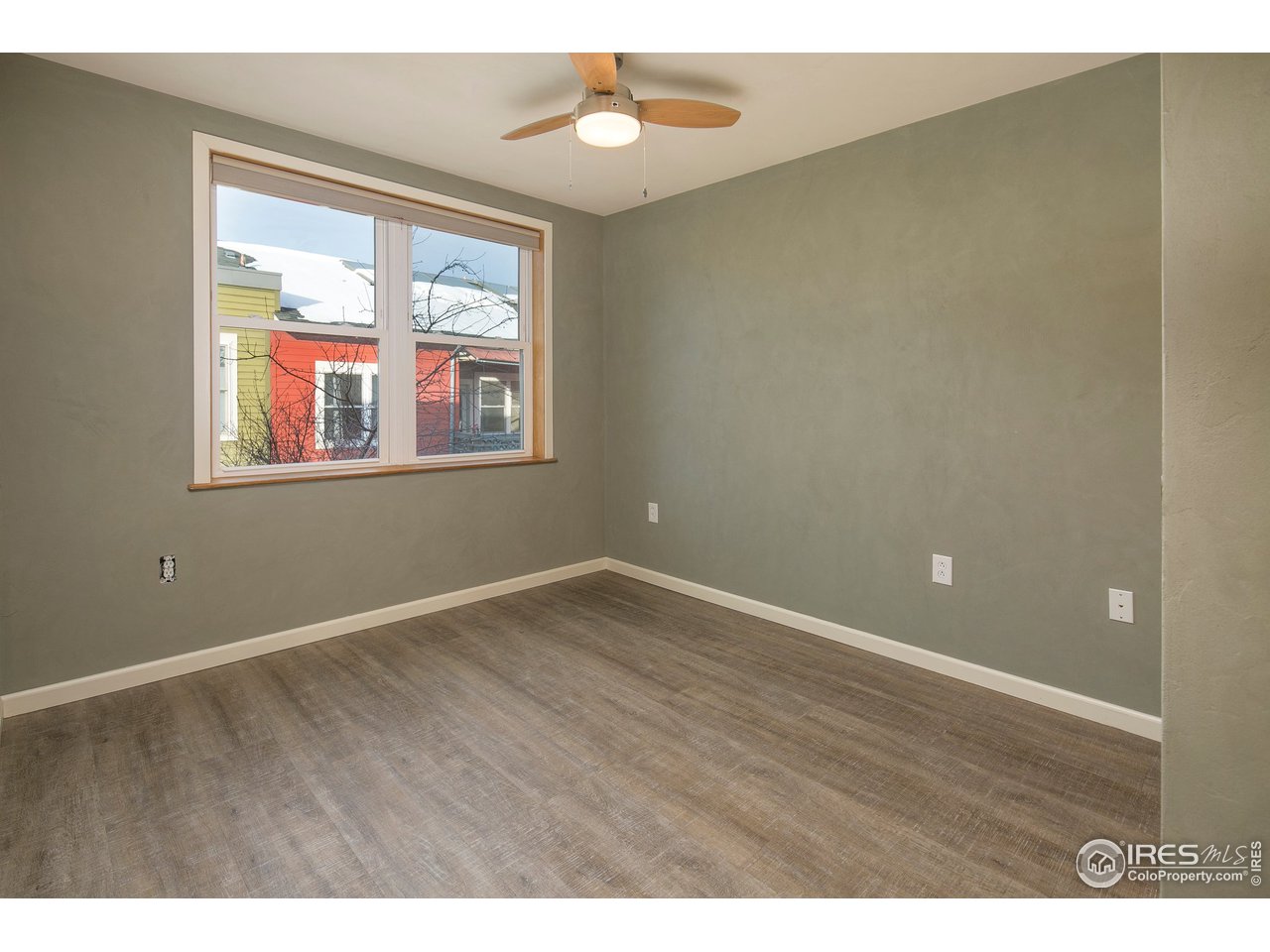 4742 16th Street Boulder, CO 80304 - Photo 17 of 38 an empty room with wooden floor and windows