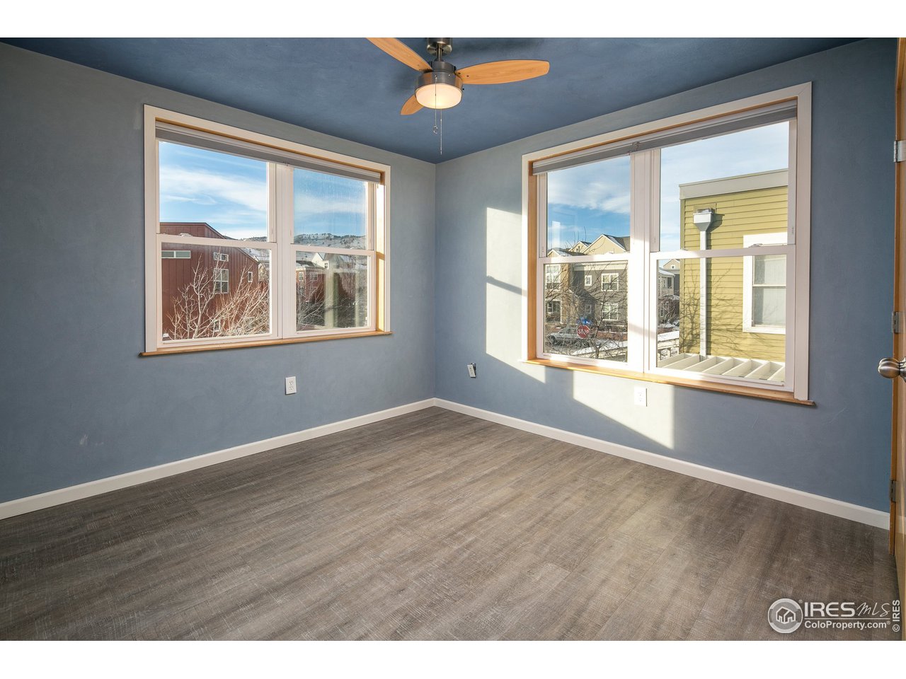4742 16th Street Boulder, CO 80304 - Photo 21 of 38 a view of an empty room with wooden floor and a window