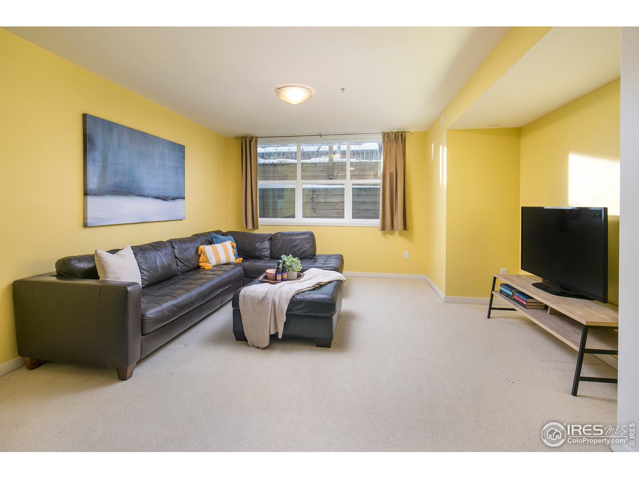 4742 16th Street Boulder, CO 80304 - Photo 23 of 38 a living room with furniture and a flat screen tv