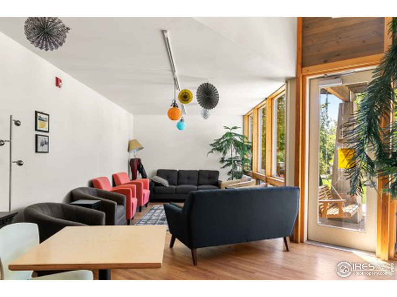 4742 16th Street Boulder, CO 80304 - Photo 36 of 38 a living room with couches and kitchen view with wooden floor