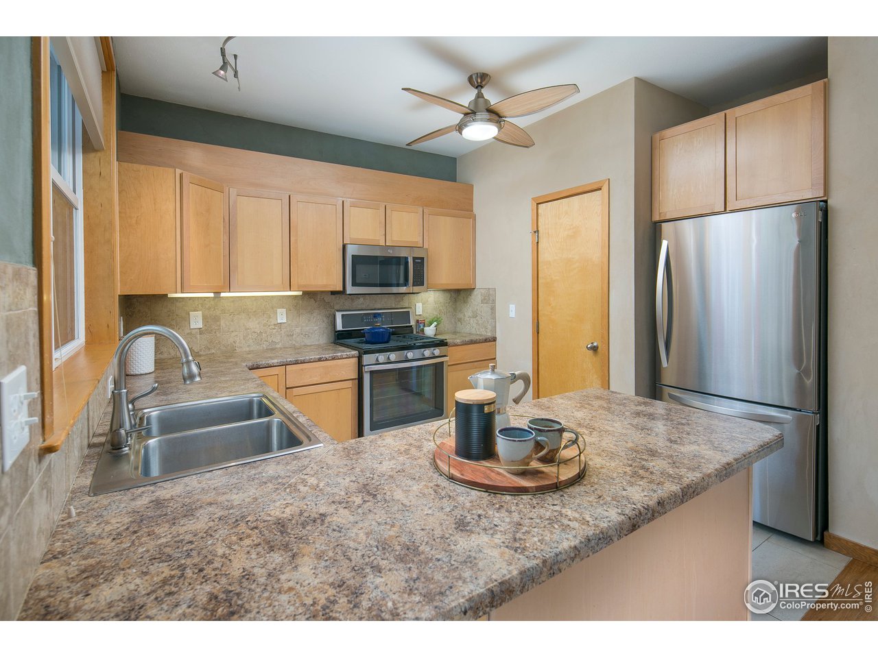 4742 16th Street Boulder, CO 80304 - Photo 9 of 38 a kitchen with kitchen island a sink appliances and cabinets