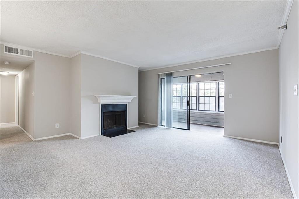 2330 Cobb Parkway Southeast, Unit 1111 Smyrna, GA 30080 - Photo 3 of 19 a view of an empty room with a fireplace and a window