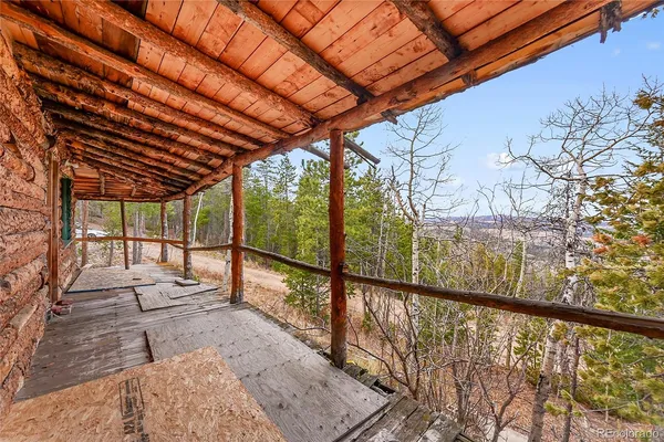 a view of a hallway with wooden floors and chandelier