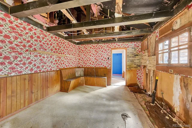 a spacious bedroom with a large bed and large windows