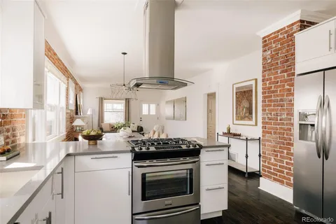 a kitchen with stainless steel appliances a stove a sink and a refrigerator