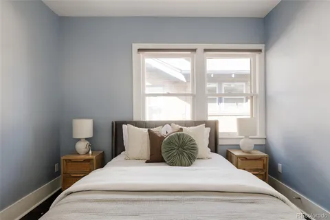 a bedroom with a bed and window