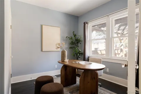 a view of a room that has a table and chairs in it