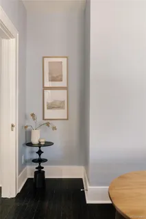 a view of a room with a wooden floor and a ceiling fan