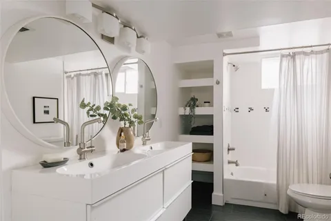 a bathroom with a shower curtain and a sink
