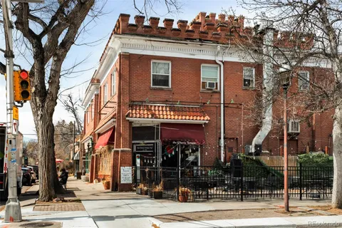 a view of a houses with snow on the road