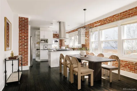 a dining room with furniture and wooden floor