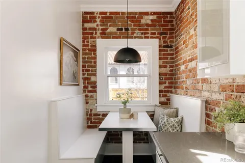 a hallway with a bench and a potted plant