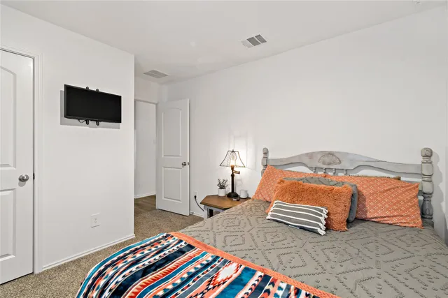 a bedroom with a bed and a television