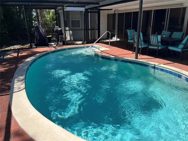a view of a backyard with a swimming pool