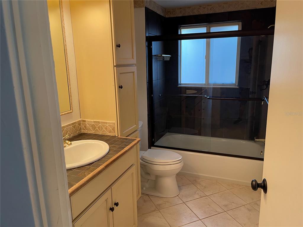 236 Davis Boulevard Sarasota, FL 34237 - Photo 9 of 10 a bathroom with a granite countertop sink toilet and shower