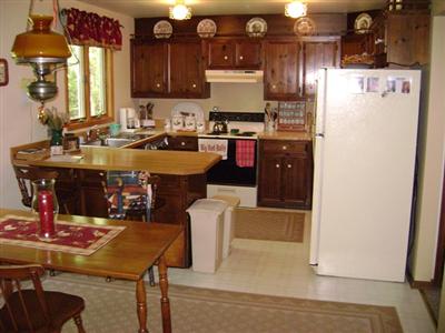 0 Smith Road Kunkletown, PA 18058 - Photo 3 of 23 a kitchen with a refrigerator a stove a sink dishwasher with a dining table and chairs