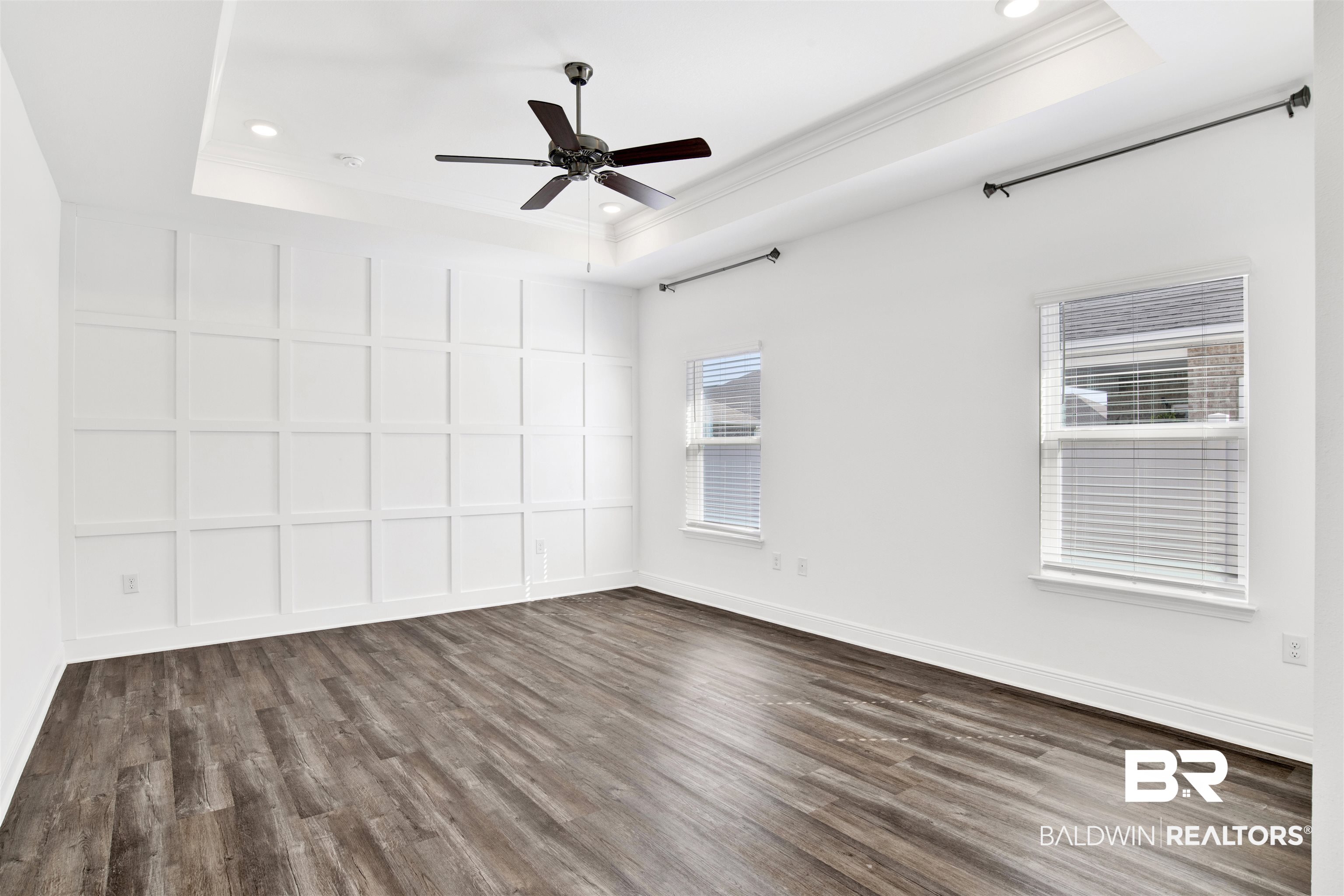 11602 Genuine Risk Circle Daphne, AL 36526 - Photo 15 of 30 Empty room with a tray ceiling, dark wood finished floors, healthy amount of natural light, a ceiling fan, and recessed lighting