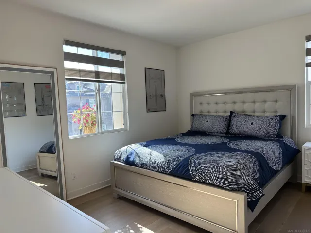 a bed sitting in a bedroom next to a window