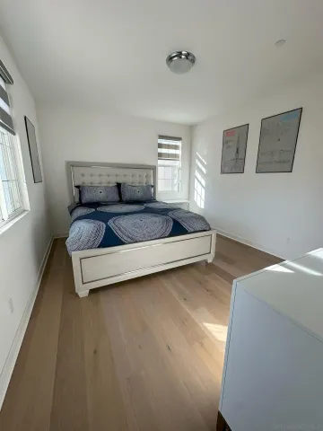 a spacious bedroom with a bed and window