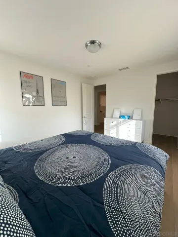 a spacious bedroom with a bed and a window