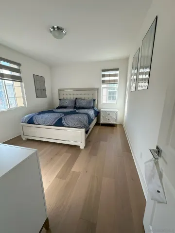 a bedroom with a bed and a couch with window