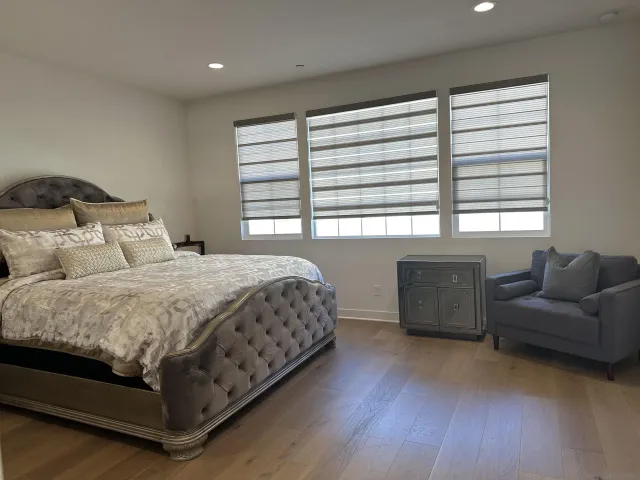 a living room with couches and dresser