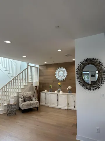 a bedroom with furniture and a wooden floor