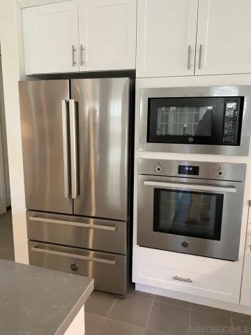 a kitchen with appliances and cabinets