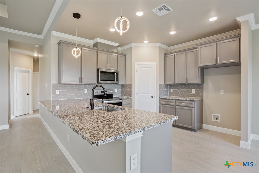 3824 Keller Road Temple, TX 76504 - Photo 9 of 28 a kitchen with stainless steel appliances granite countertop a sink stove and refrigerator
