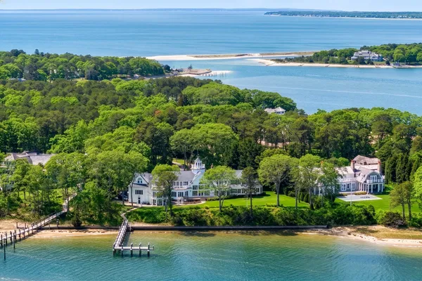 an aerial view of ocean residential house with outdoor space and trees all around