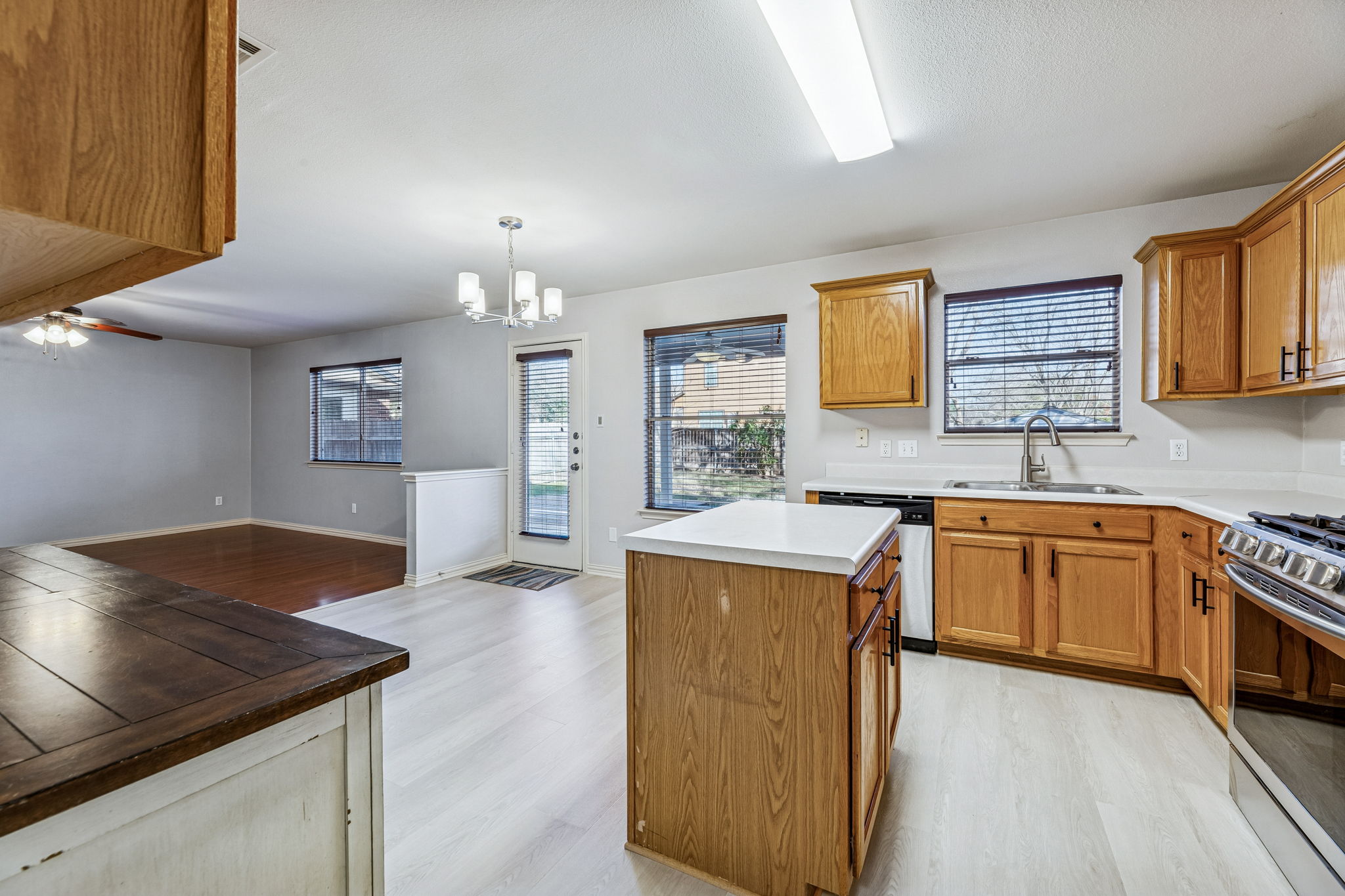 1608 Melibee Trail Austin, TX 78748 - Photo 12 of 29 a kitchen with granite countertop a sink cabinets and wooden floor