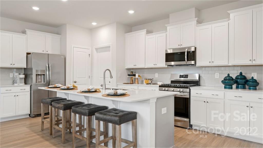 6520 Gopher Road, Unit 322 Lancaster, SC 29720 - Photo 2 of 25 a kitchen with stainless steel appliances a stove a sink a microwave a refrigerator and cabinets