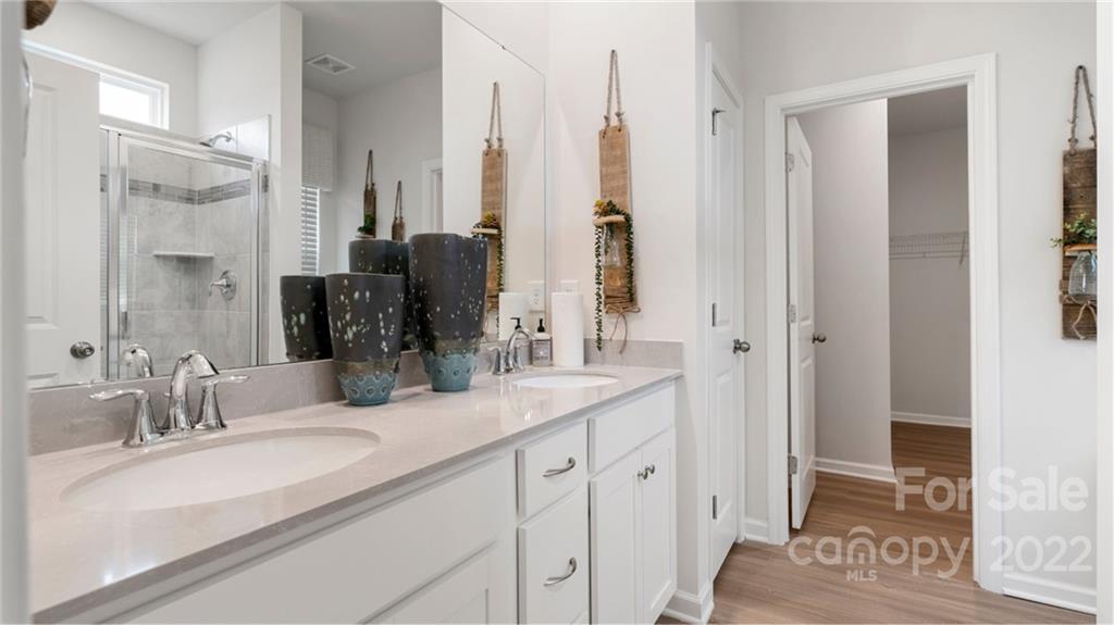 6520 Gopher Road, Unit 322 Lancaster, SC 29720 - Photo 9 of 25 a bathroom with double vanity sinks a mirror and a shower
