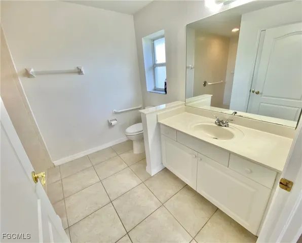 a spacious bathroom with a sink toilet and shower
