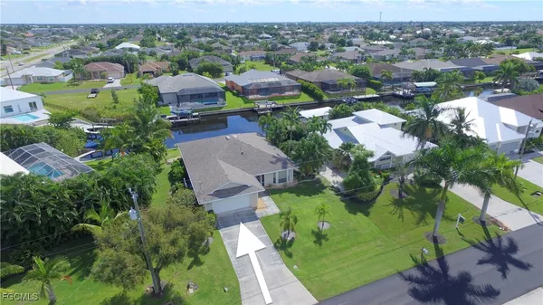 an aerial view of multiple houses with yard