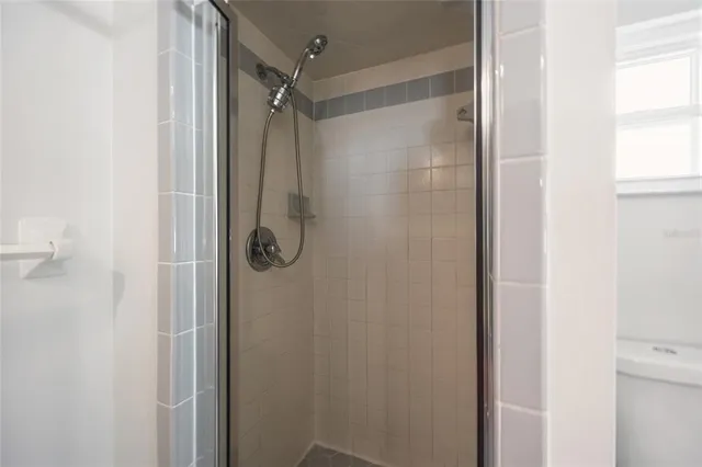 a bathroom with a glass shower door