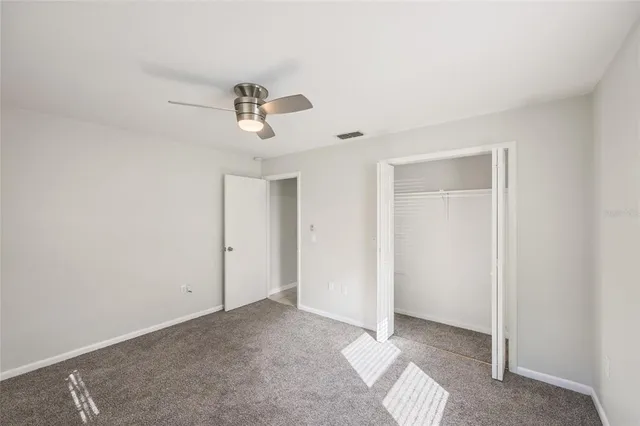 a view of room with a ceiling fan