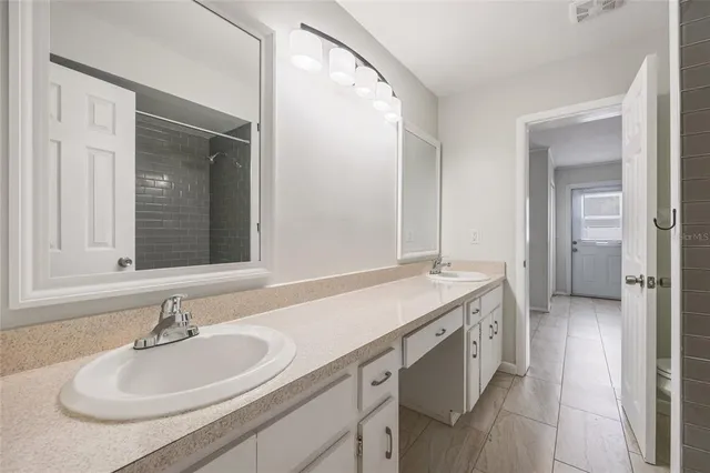a spacious bathroom with a sink and a mirror