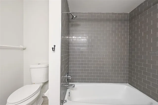 a bathroom with a bathtub and a toilet