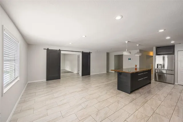 a large room with a large window and stainless steel appliances