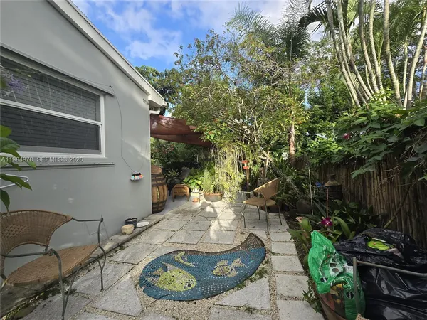 a view of a backyard with potted plants