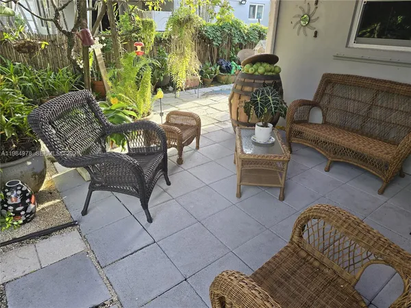 a view of a patio with couches and potted plants