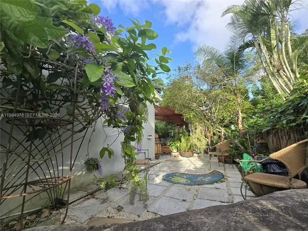 a backyard of a house with a table and chairs