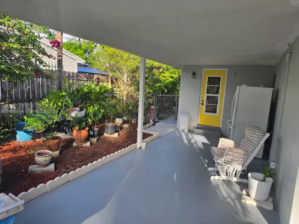 a swimming pool with potted plants and wooden fence