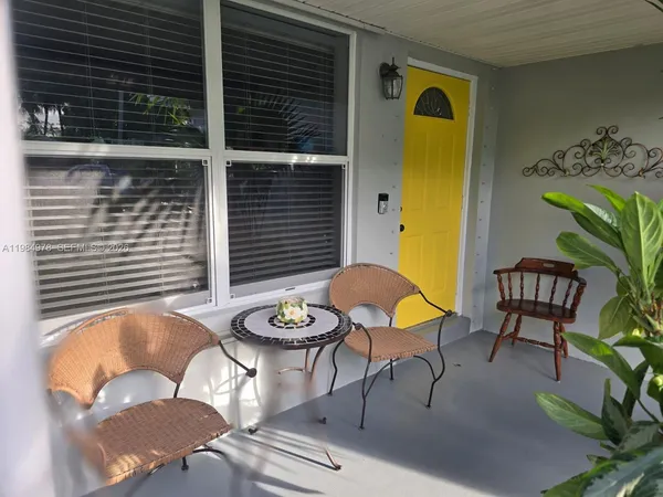 a balcony with table and chairs