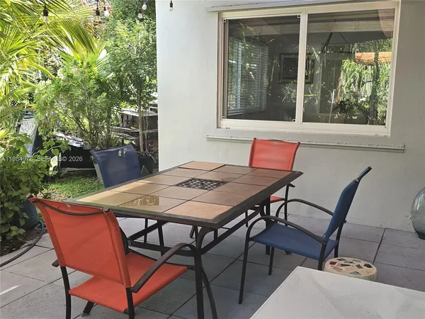 a view of a house with backyard and sitting area
