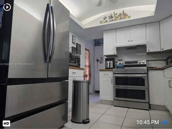 a kitchen with stainless steel appliances a refrigerator sink and cabinets