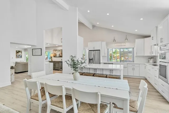 a kitchen with granite countertop a sink stainless steel appliances and cabinets